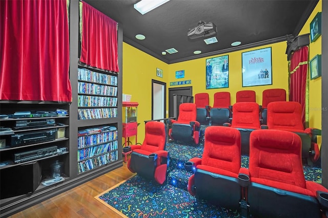 cinema room featuring hardwood / wood-style floors, a textured ceiling, and crown molding