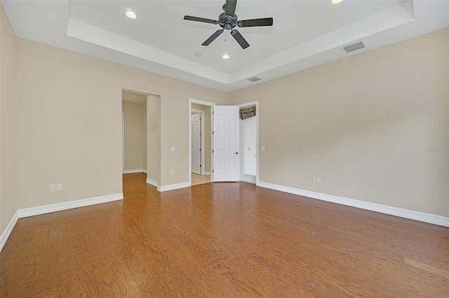 1233 Aquila Loop, Celebration, FL 34747 - unfurnished room with a tray ceiling, recessed lighting, wood finished floors, a ceiling fan, and baseboards