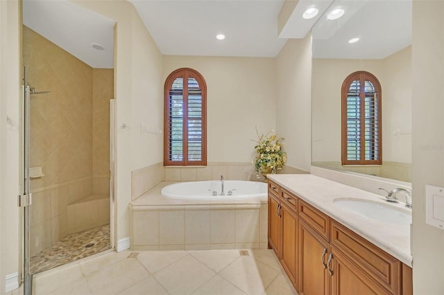 1233 Aquila Loop, Celebration, FL 34747 - full bath with vanity, a garden tub, a shower stall, tile patterned floors, and recessed lighting