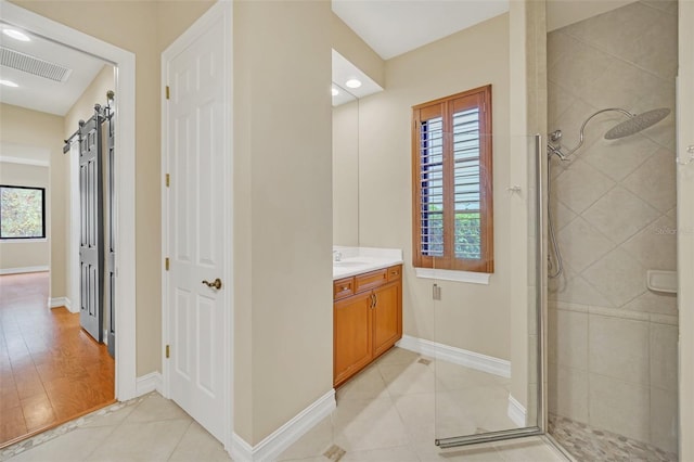 bathroom with hardwood / wood-style flooring, vanity, an enclosed shower, and a wealth of natural light