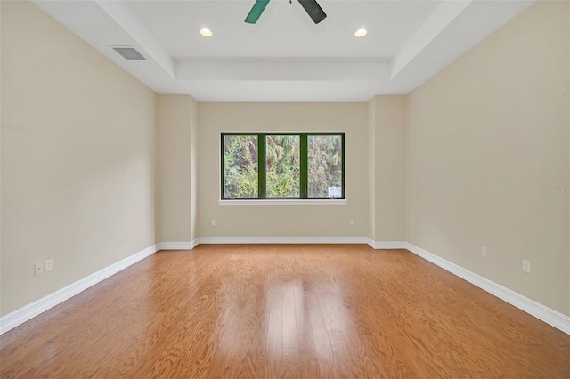 1233 Aquila Loop, Celebration, FL 34747 - spare room with a tray ceiling, a ceiling fan, light wood finished floors, baseboards, and recessed lighting