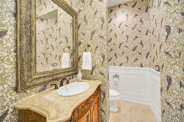 bathroom with tile patterned flooring, vanity, and toilet