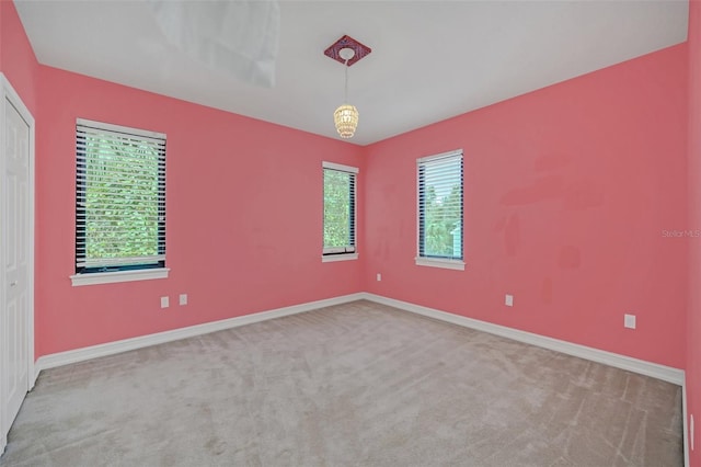 carpeted empty room with a wealth of natural light