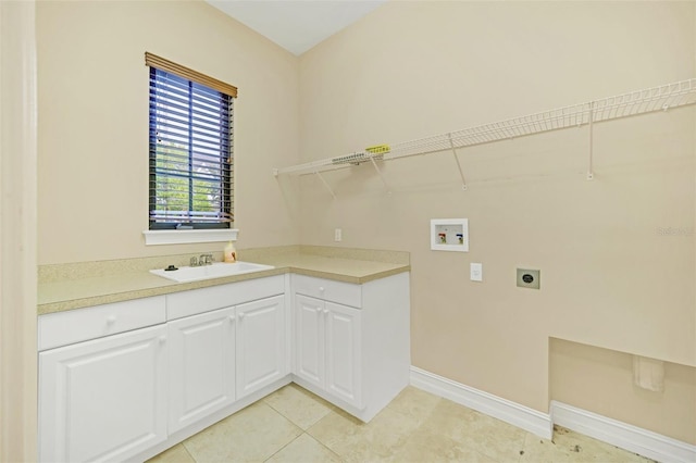 1233 Aquila Loop, Celebration, FL 34747 - laundry area with electric dryer hookup, washer hookup, a sink, baseboards, and light tile patterned floors