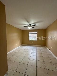 unfurnished room featuring ceiling fan and light tile patterned floors