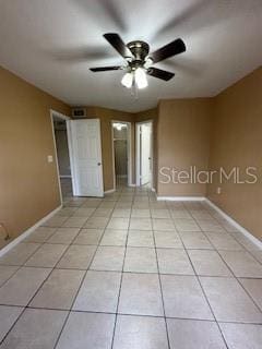 unfurnished bedroom with ceiling fan and light tile patterned floors