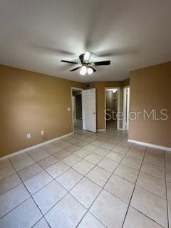 tiled empty room with ceiling fan