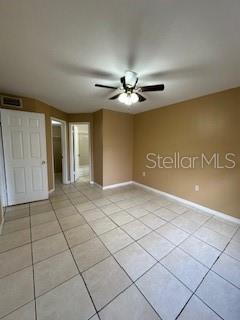 unfurnished bedroom featuring ceiling fan and light tile patterned flooring