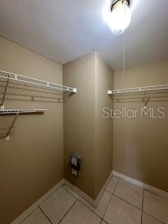 clothes washing area featuring tile patterned flooring