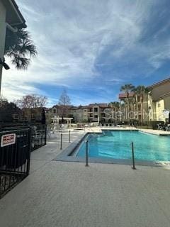 view of swimming pool featuring a patio area