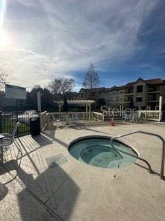 view of pool with a patio and a hot tub