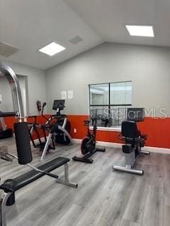 workout area with wood-type flooring and lofted ceiling