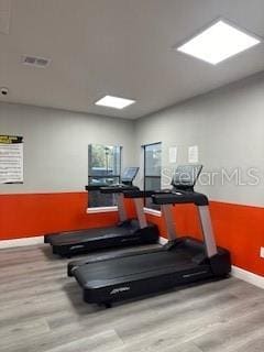 exercise area featuring light hardwood / wood-style floors