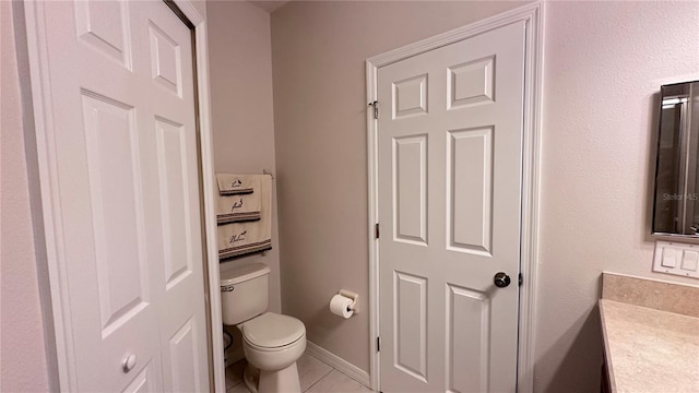 bathroom with tile patterned floors, vanity, and toilet