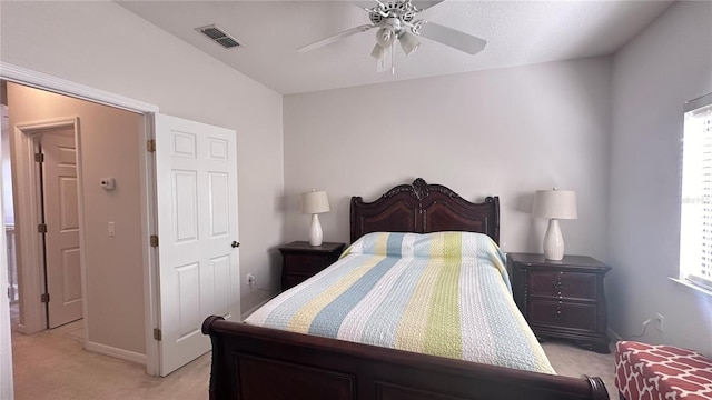 bedroom with multiple windows, ceiling fan, and light colored carpet