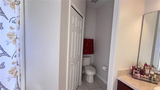 bathroom featuring toilet, vanity, tile patterned floors, and a shower with shower curtain