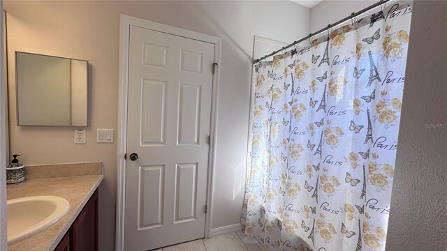 bathroom featuring vanity, tile patterned floors, and curtained shower