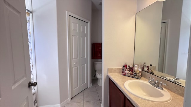 bathroom with tile patterned flooring, vanity, and toilet