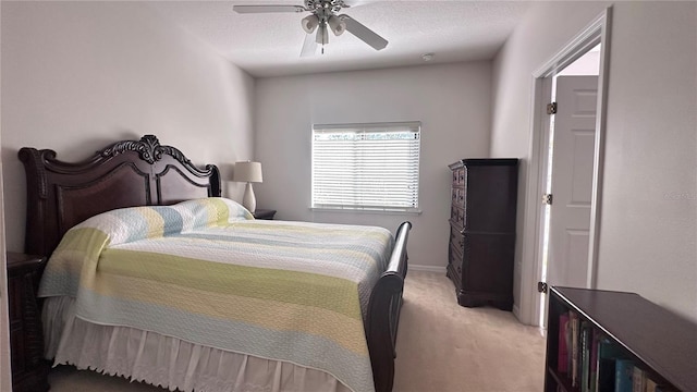 carpeted bedroom with ceiling fan and a textured ceiling