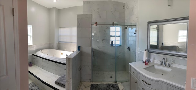 bathroom featuring separate shower and tub and vanity