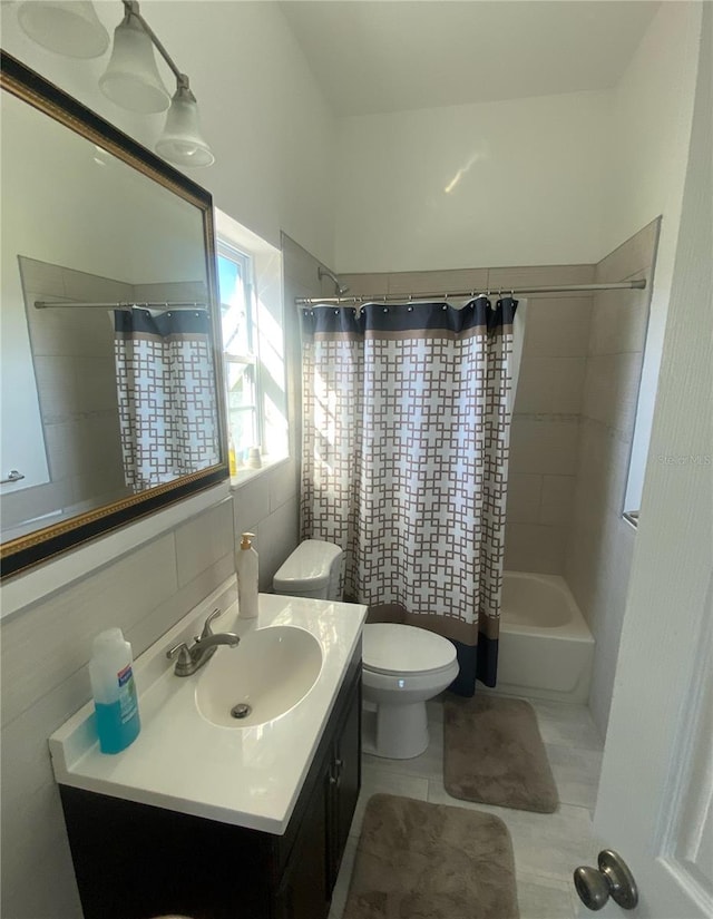 full bathroom with tile walls, vanity, shower / tub combo, tile patterned flooring, and toilet