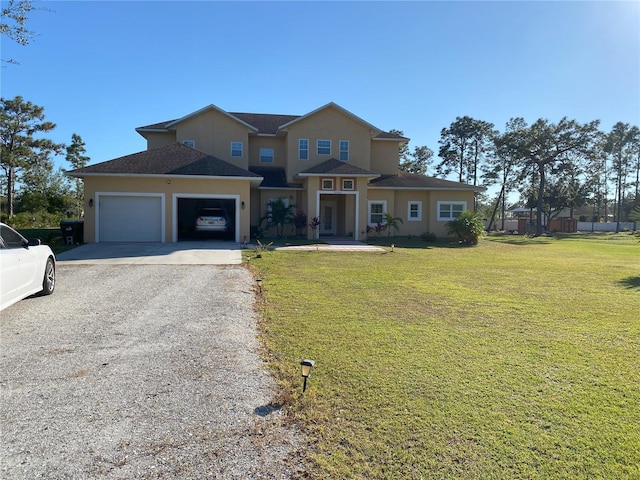 view of front of house featuring a garage and a front lawn