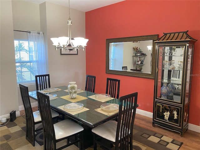 dining space featuring a chandelier and wood-type flooring