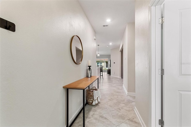 hallway featuring light tile patterned floors