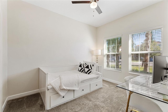 carpeted bedroom featuring ceiling fan and multiple windows