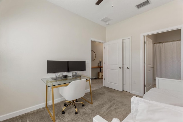 carpeted office featuring ceiling fan