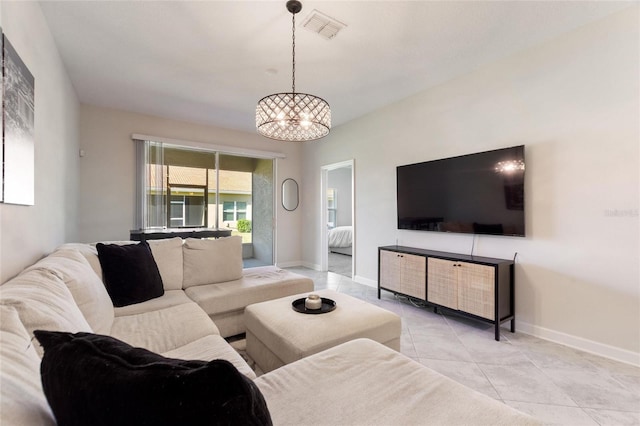 living room with light tile patterned floors and a notable chandelier