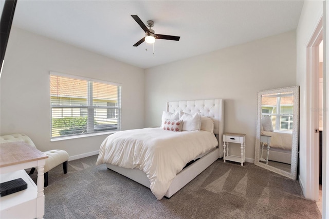 bedroom featuring ceiling fan, dark carpet, and multiple windows