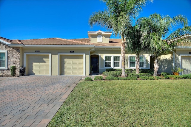 mediterranean / spanish-style home with a garage and a front yard