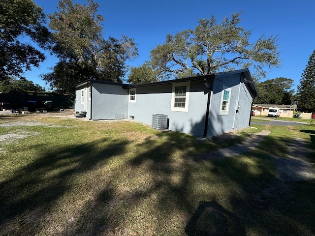 view of home's exterior with a lawn and central air condition unit