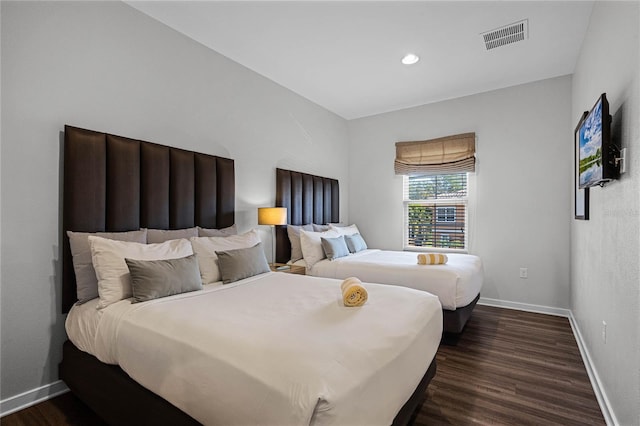 bedroom with dark wood-type flooring