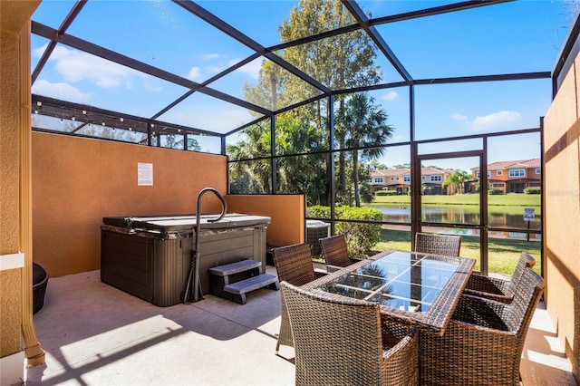 view of patio with central AC, a water view, a hot tub, and a lanai