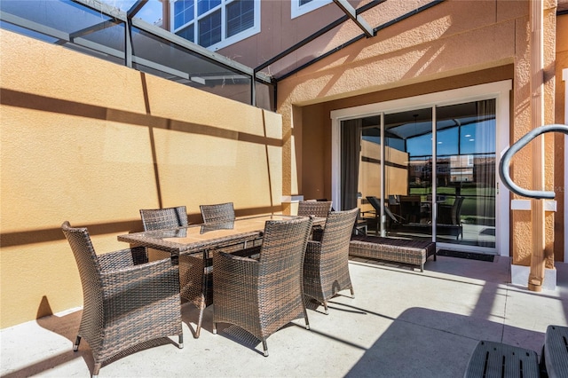 view of patio / terrace featuring glass enclosure