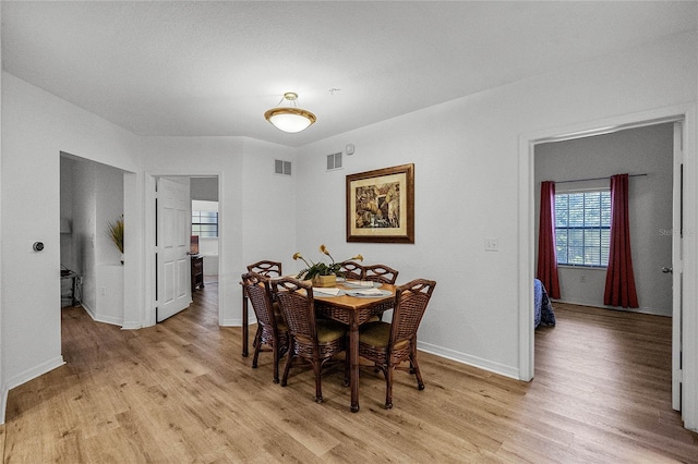 dining space with light wood-type flooring