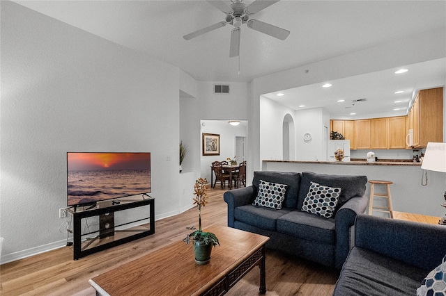 living room featuring light hardwood / wood-style flooring and ceiling fan