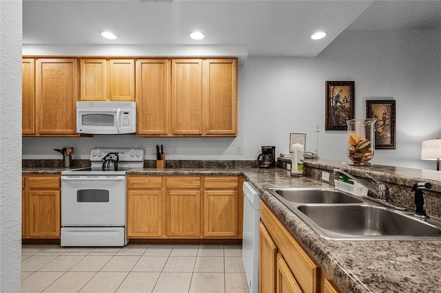 kitchen featuring white appliances, sink, and light tile patterned floors