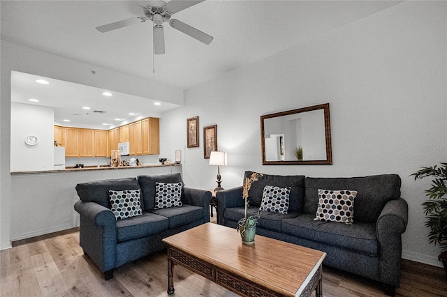 living room with ceiling fan and light hardwood / wood-style floors