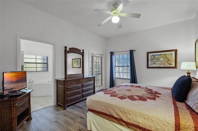 bedroom featuring ensuite bath, ceiling fan, and light hardwood / wood-style floors