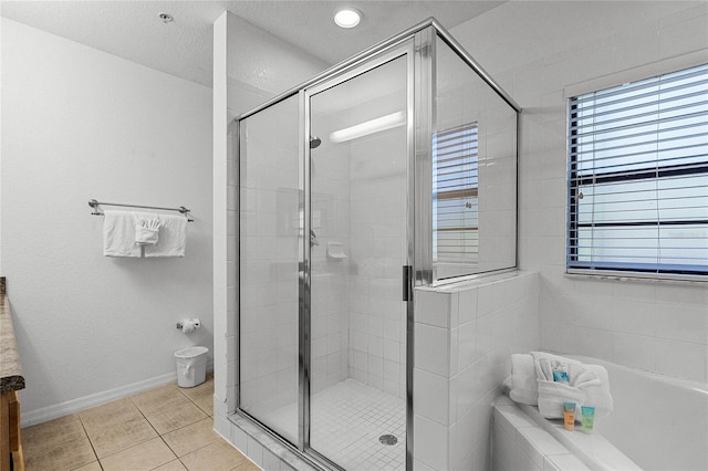 bathroom with tile patterned flooring, a textured ceiling, vanity, and independent shower and bath