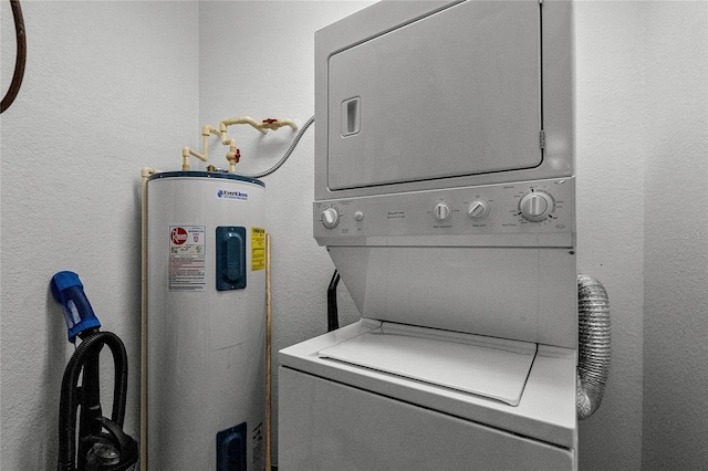 laundry room featuring electric water heater and stacked washer / drying machine