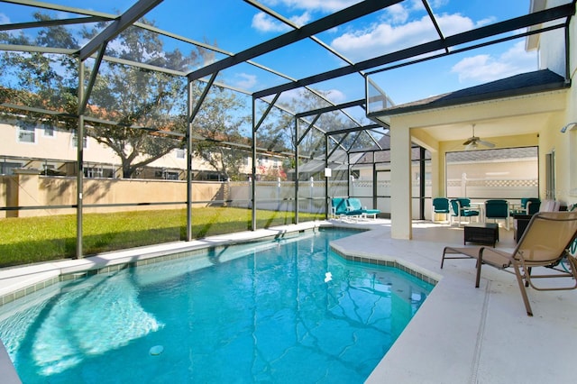 view of swimming pool with a lanai, a patio area, ceiling fan, and a lawn