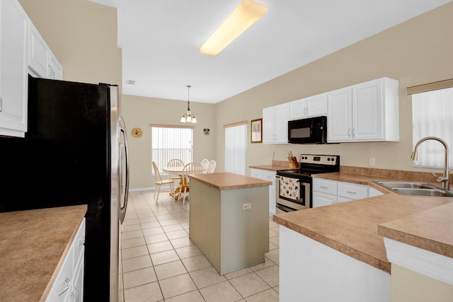 kitchen featuring white cabinets, hanging light fixtures, sink, appliances with stainless steel finishes, and a kitchen island