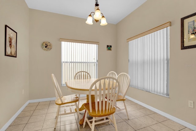 dining room featuring light tile patterned flooring and an inviting chandelier