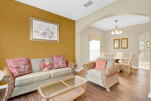 living room featuring hardwood / wood-style flooring and a chandelier