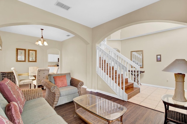 living room featuring a chandelier and light hardwood / wood-style floors