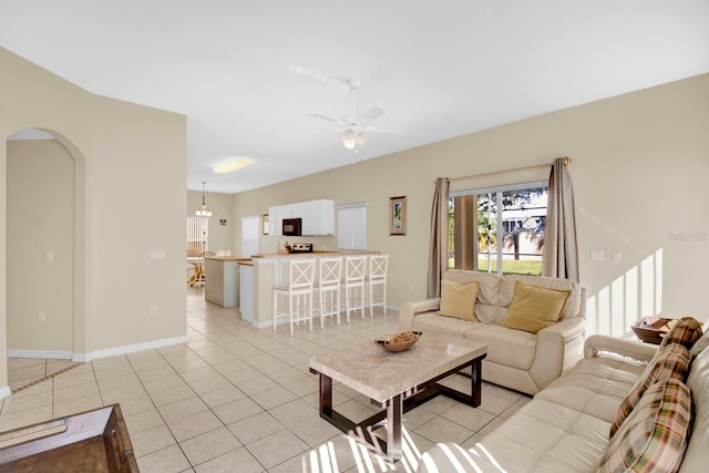 tiled living room with ceiling fan